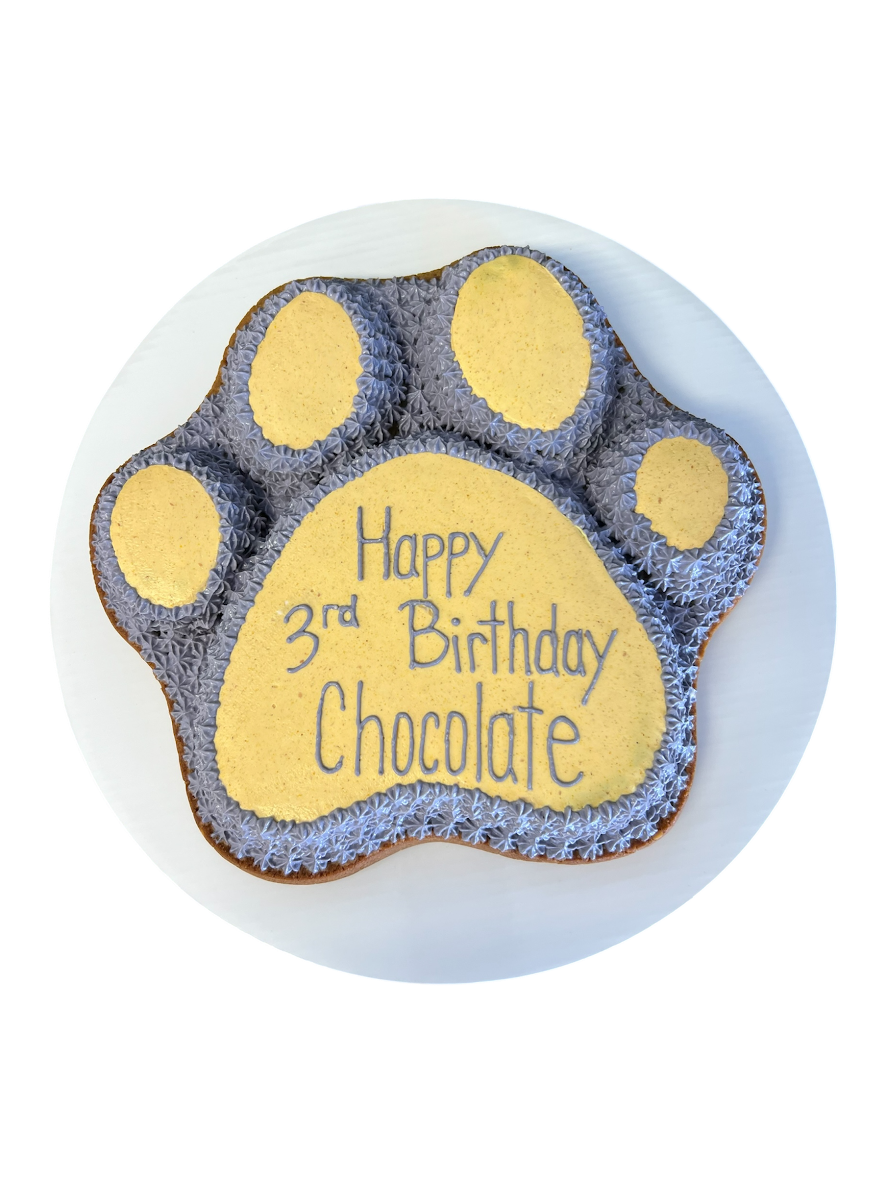Paw print dog cake for a 3rd birthday with chocolate flavor and decorative message