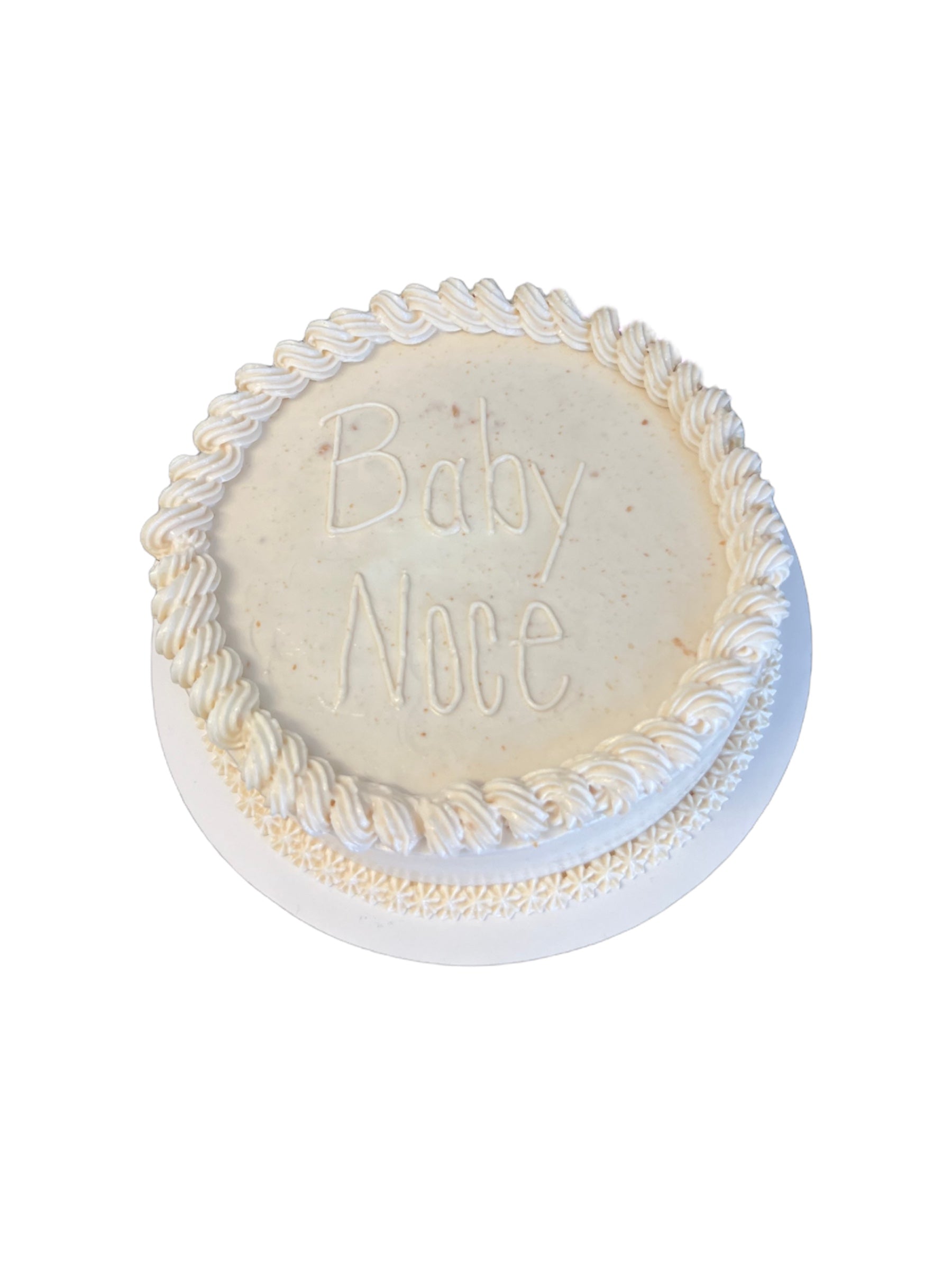 The Barkery LLC gender reveal dog cake with white frosting and Baby Noce inscription