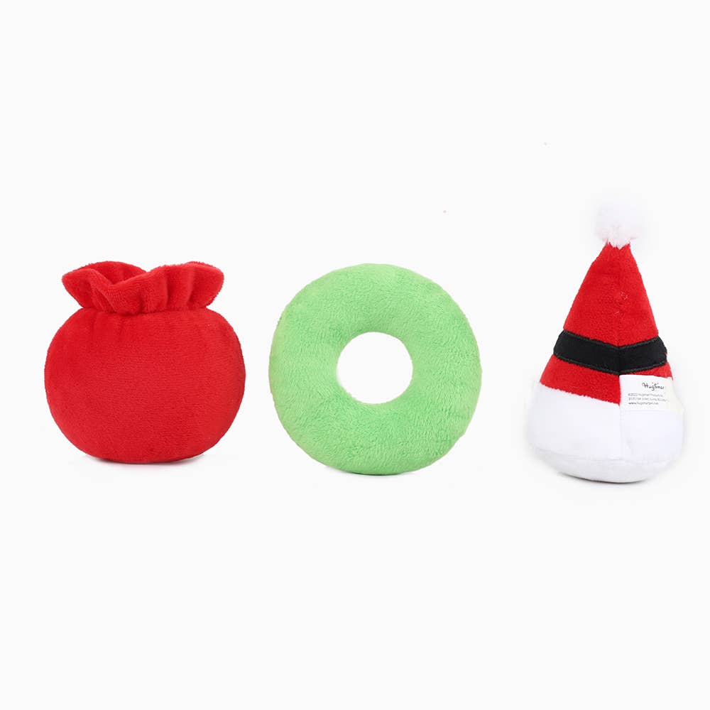 Hugsmart holiday dog squeaker toys including a red sack, green donut, and Santa hat for festive play
