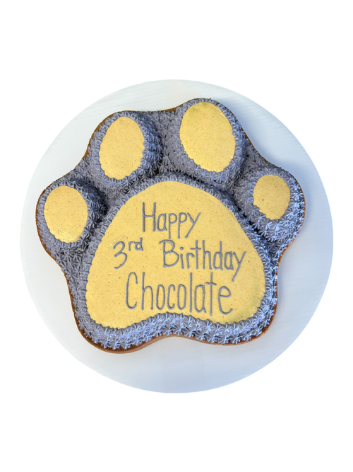 Paw print dog cake for a 3rd birthday with chocolate flavor and decorative message